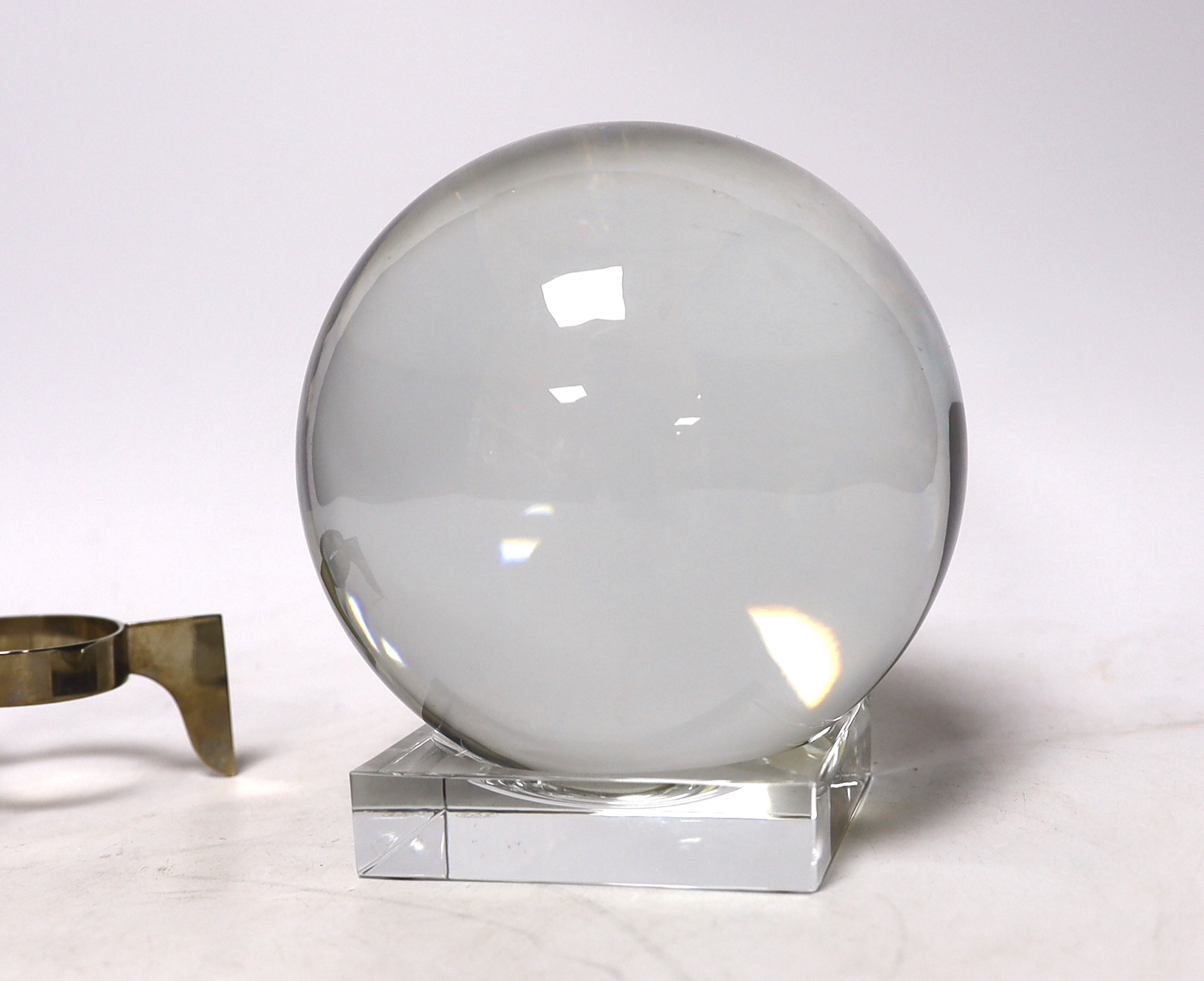 A large Baccarat glass crystal ball with two Baccarat stands, 16cm high